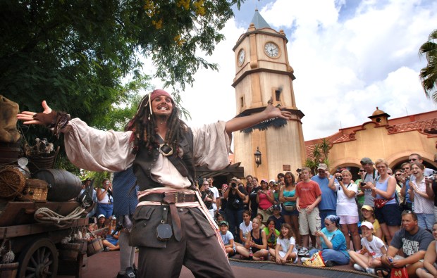 An actor portraying the character Capt. Jack Sparrow entertains the crowds in front of the Pirates of the Caribbean attraction at the Magic Kingdom at Walt Disney World, near Orlando, Friday, July 7, 2006. The classic ride officially re-opened Friday after a 3-month closure to add characters and features from the blockbuster motion picture franchise. The Magic Kingdom's re-opening of the Pirates attraction Friday coincided with the nationwide release of the movie "Pirates of the Caribbean: Dead Man's Chest." TO GO STANDALONE FOR DAILY BIZ (Joe Burbank/Orlando Sentinel) trax 00079881A