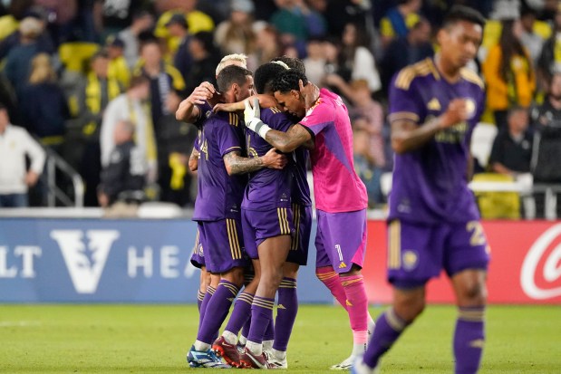 Orlando City players celebrate the team's 1-0 win against Nashville SC after an MLS playoff soccer match Tuesday, Nov. 7, 2023, in Nashville, Tenn. (AP Photo/George Walker IV)