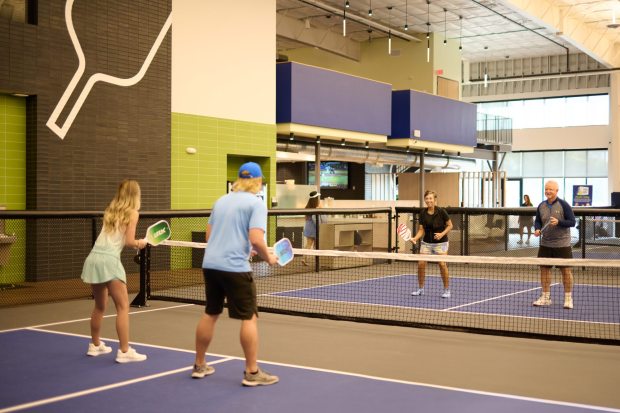 Each Pickleball Club is designed with 28-foot ceilings and cork floors to provide the best experience for the frequent player. (Courtesy of The Pickleball Club)