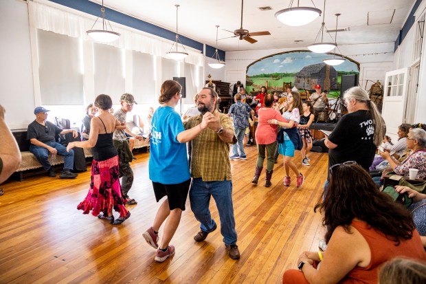 Visitors participate in contra dancing inside the schoolhouse during the 47th annual Fall Country Jamboree at the Barberville Pioneer Settlement in Volusia County. (Patrick Connolly/Orlando Sentinel)