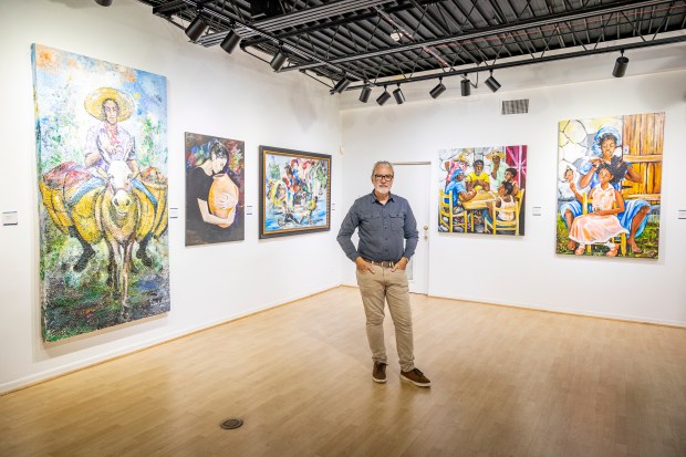 Peter Schreyer, Crealdé's CEO and executive director, is surrounded by the work of Hatian-American artist Patrick Noze in the gallery at Crealdé School of Art in Winter Park on Sept. 21, 2023. (Patrick Connolly/Orlando Sentinel)