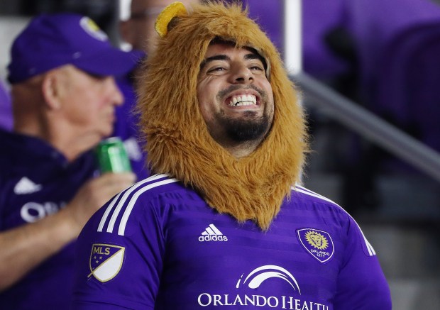 An Orlando City Lions fan cheers during the MLS playoff match against Nashville SC at Orlando's Exploria Stadium Monday. (Stephen M. Dowell/Orlando Sentinel)