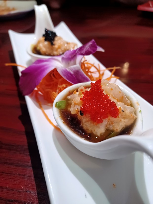 You can get spicy scallop shots with or without sake, though enjoying the latter amps the pleasant slurp factor of a cold tasting that's best done in one rich bite. (Amy Drew Thompson/Orlando Sentinel)