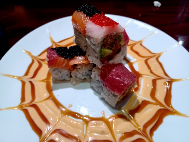 The signature Black Widow Roll doesn't look as dramatic when you get it to go, but it is just as tasty. Love the pop of all that tobiko. (Amy Drew Thompson/Orlando Sentinel)