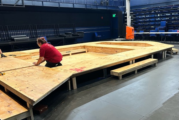 Rollins College technical theater specialist Mary Raker works on the pool that will form the centerpiece of the college's production of "Metamorphoses," the first show in the new Tiedtke Theatre & Dance Centre. (Courtesy Rollins College)